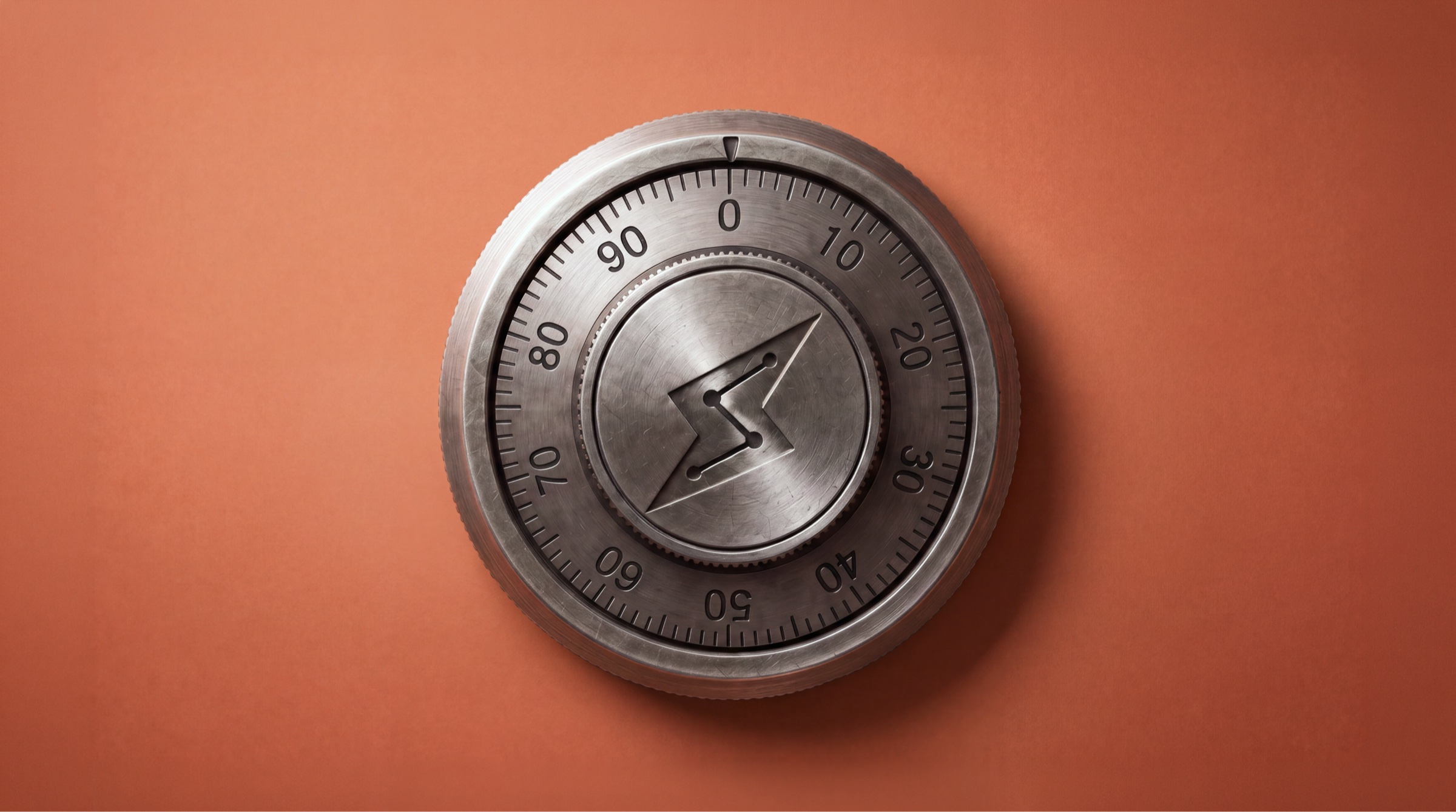 A combination dial on a safe door, the Accomplish bolt engraved at its center